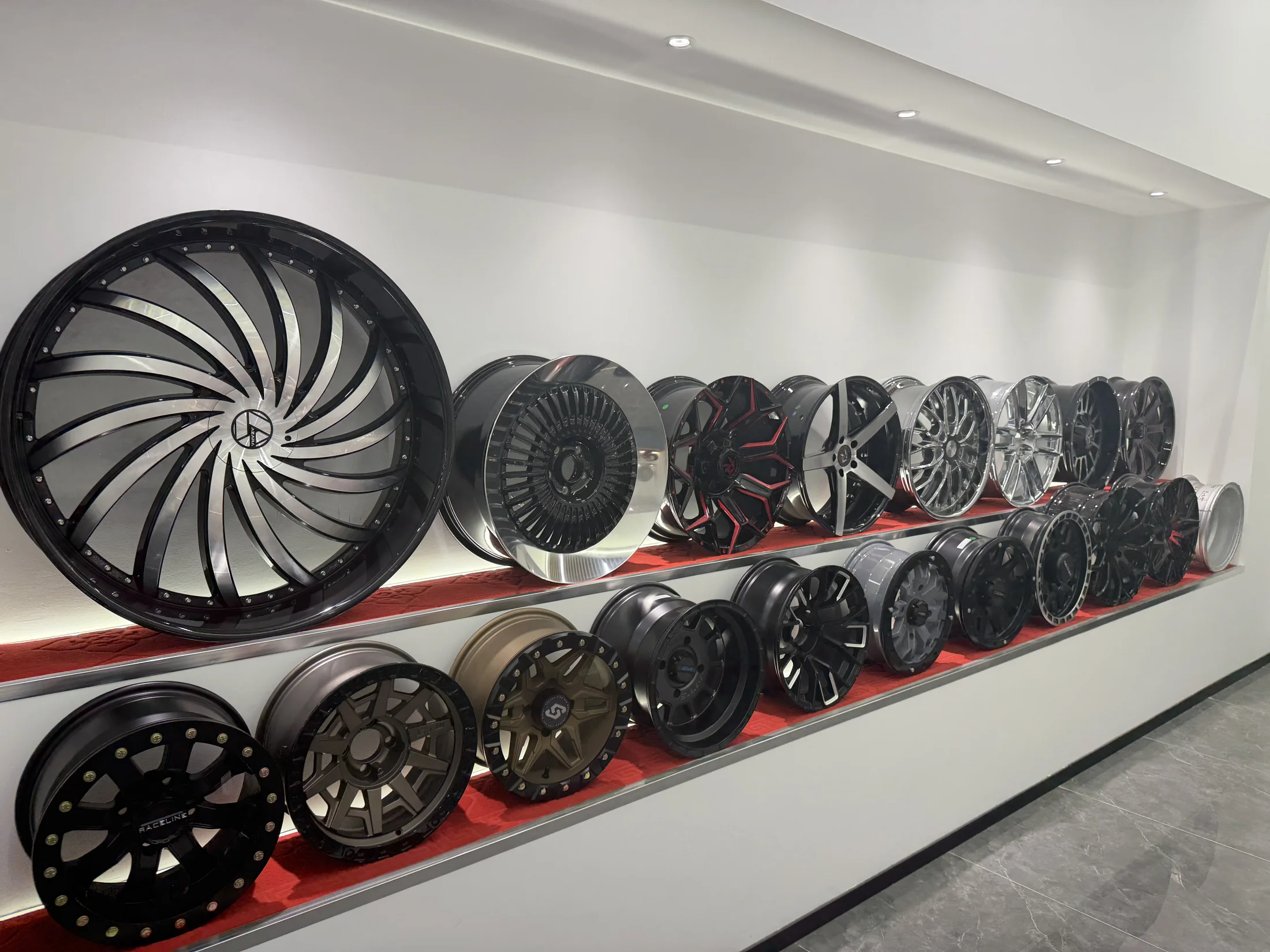 Wall display of finished cast aluminum wheels in a range of designs and finishes